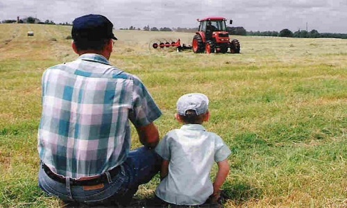 Man and Son watching Tractor