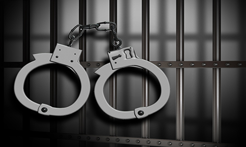 Handcuffs on Jail Bars