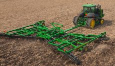 Farm Tractor in field with ag implement