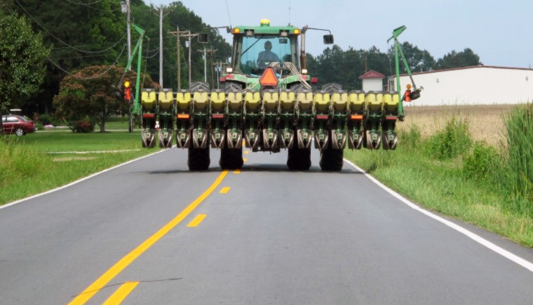 Tractor on Road with Farm Implement