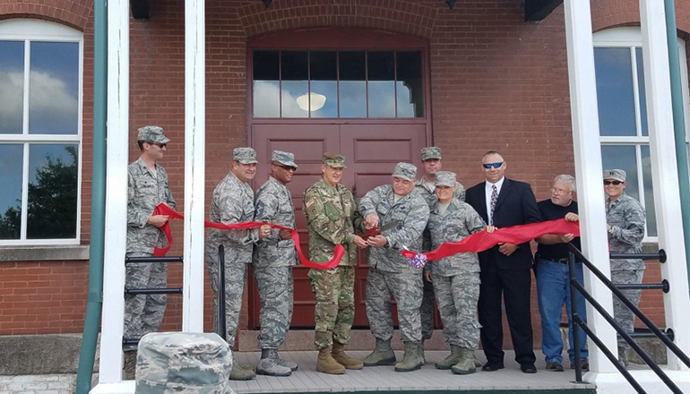 Missouri National Guard’s adjutant general, U.S. Army Maj. Gen. Steve Danner (center left) and Missouri Air National Guard 131st Bomb Wing commander, Col Ken Eaves, cut the ribbon that officially opens historic building 29 at Jefferson Barracks Air National Guard Base.