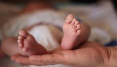 Mother holding babys feet