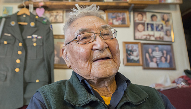 Retired Sgt. 1st Class Sam Jackson, who served in the Alaska Territorial Guard during World War II, poses for a photo inside his home in Kwethluk, Alaska, Sept. 23, 2017. Jackson and more than 6,300 native Alaskans voluntarily joined the territorial guard to defend their homeland against a potential