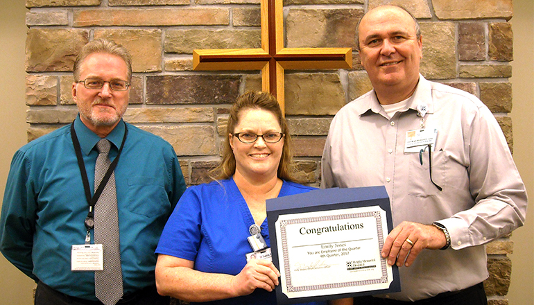 Emily Jones(middle) receives the Wright Memorial Hospital Employee of the Quarter Award for fourth quarter 2017 from Gary Jordan, CEO (right), and Bob Moore, manager, Radiology (left).