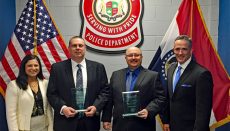 U.S. Attorney Timothy Garrison (right) and Assistant U.S. Attorney Ami Harshad Miller (left) present the award to Detectives Larry Roller and Charles Root.