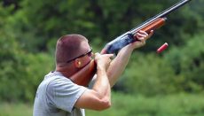 Man Firing Shotgun