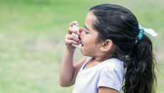 Child using asthma inhaler