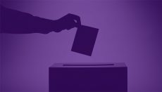 Hand dropping ballot in voting box