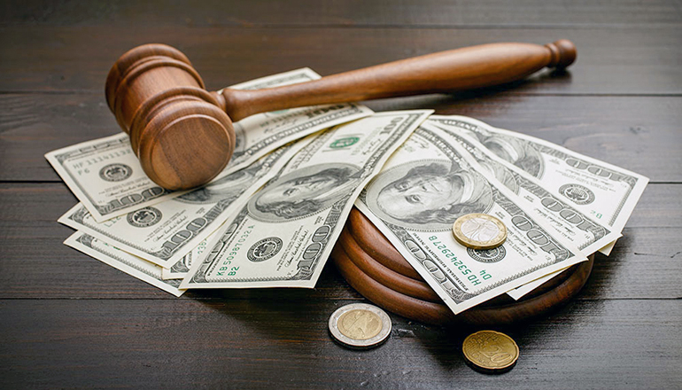 Bail Bond or Gavel on desk with cash