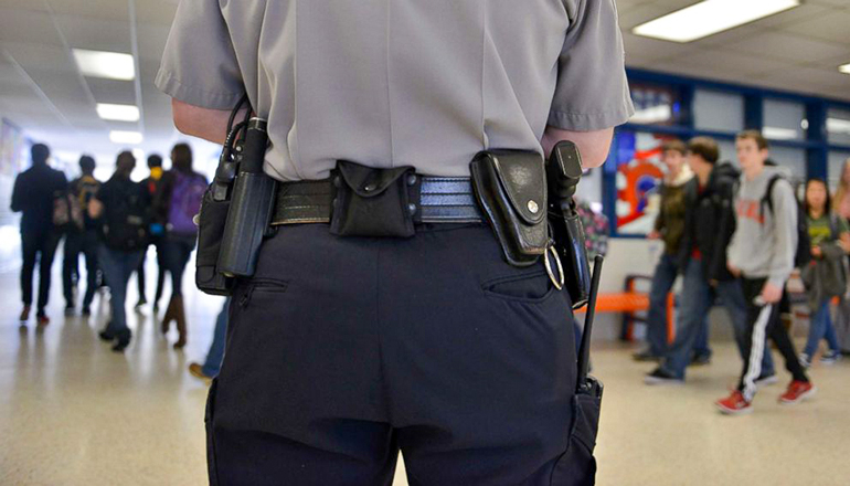 Officer in school building carrying weapon