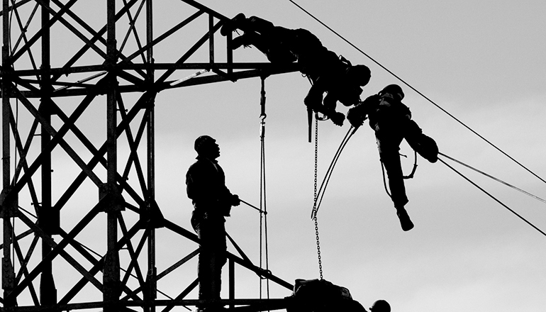 Linemen on electric tower