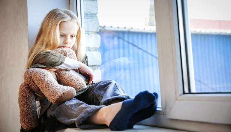 Child sitting on window sill (Children)
