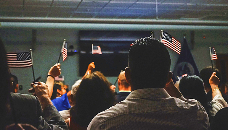 Immigrants waving US Flags