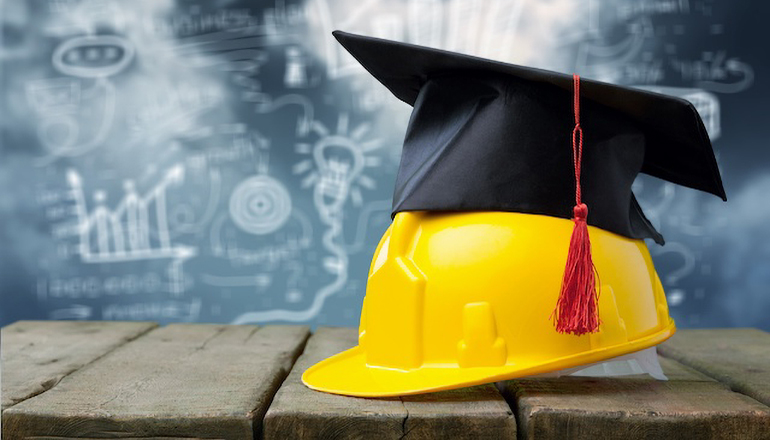 Graduation cap on hardhat (apprentice or education or school or jobs)