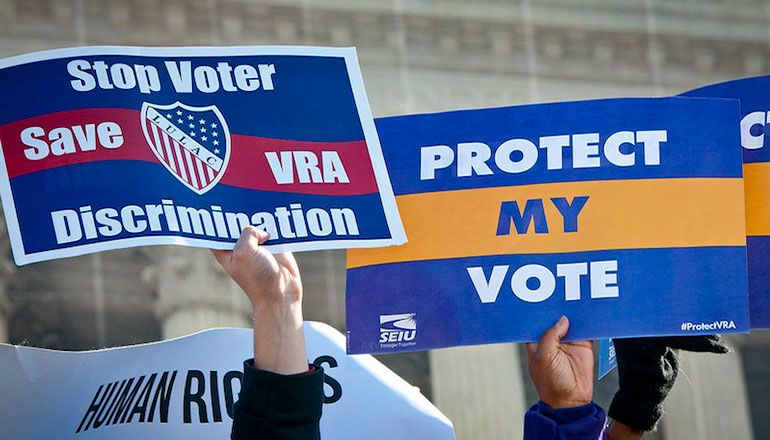 Protesters with stop discrimination signs and protect vote