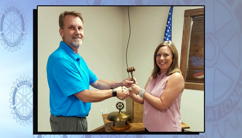 The passing of the gave between Past President Kim Washburn and new Rotary President Brian Upton