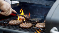 Photo of person cooking on outdoor grill (Courtesy of Unsplash)