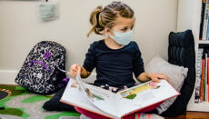 Little Girl in Class at School Wearing Mask