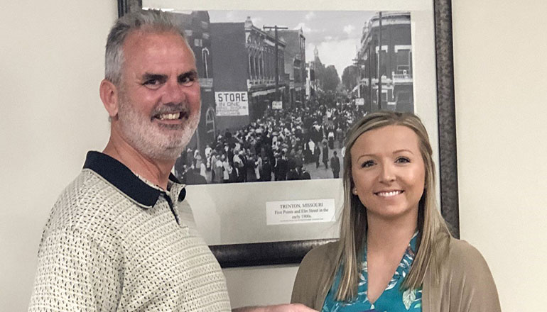 Megan Derry receiving the Paul Harris award from her uncle, Don Purkapile