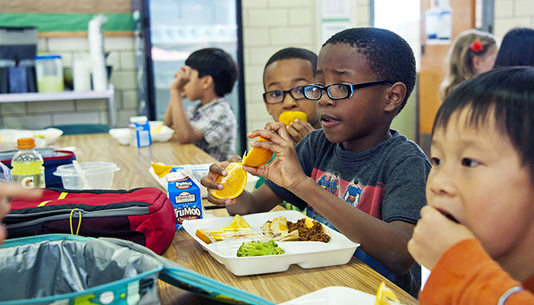 Children eating lunch in a school cafeteria (Photo by CDC on Unsplash)