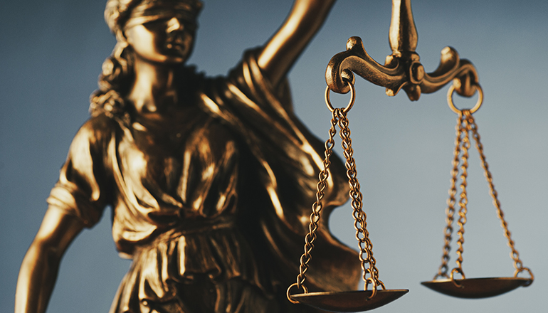 Figure of Justice holding the scales of justice (Photo licensed via Envato Elements)