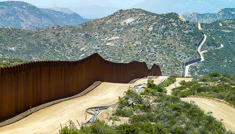 Photo of border wall (Photo via Greg Bulla on Unsplash)