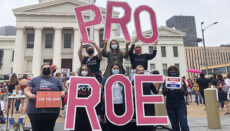 Protesters holding Pro Roe signs also abortion