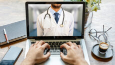 Telemedicine concept. Doctor GP on a computer screen, office des