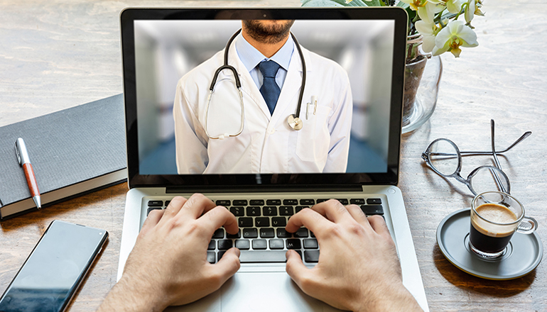 Telemedicine concept. Doctor GP on a computer screen, office des