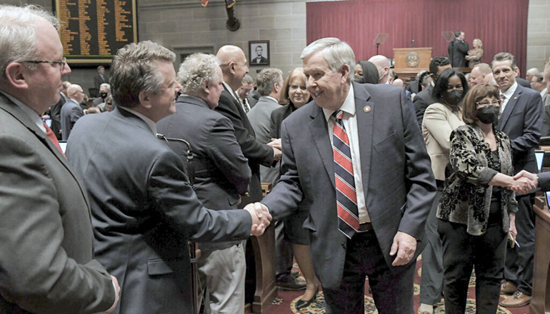 Governor Parson talks with lawmakers as he leaves House Chamber after State of the State address (Photo courtesy of Tim Bommel - Missouri House)
