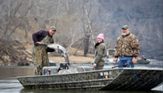 Three fisherman on a boat with a paddlefish (Photo courtesy Missouri Department of Conservation)