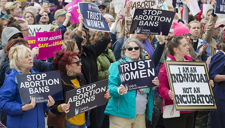 Group of protesters with stop abortion ban signs (Photo courtesy Missouri News Service)