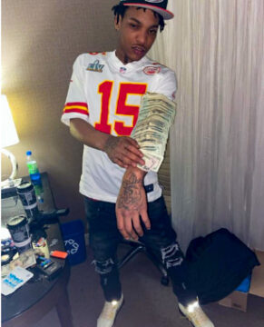 Keylan Williams posted this photo of himself with firearms and cash to his Instagram account