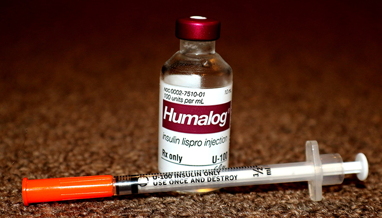 Bottle of Insulin and syringe or needle (Photo by David Moruzzi on Unsplash)