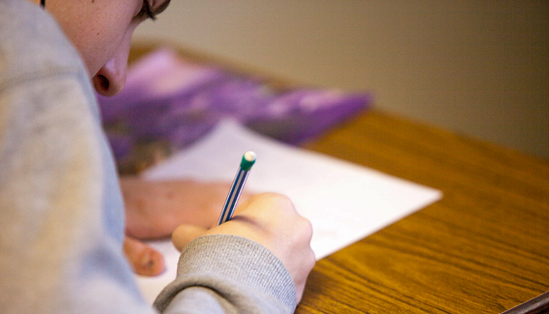 Photo of student taking a test (Photo courtesy Ben Mullins on Unsplash)