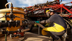 Farmer using safety precautions to fill his sprayer with pesticide after obtaining his pesticide applicator training