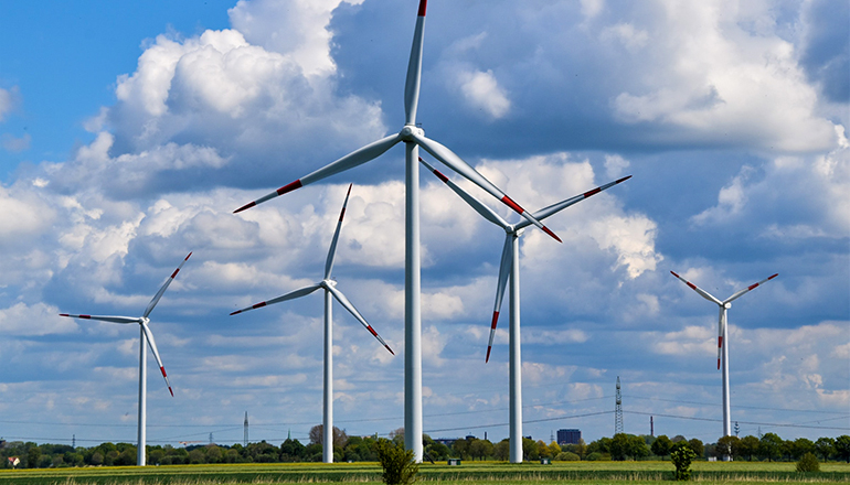 Wind Turbines in a field (Photo by Waldemar on Unsplash)
