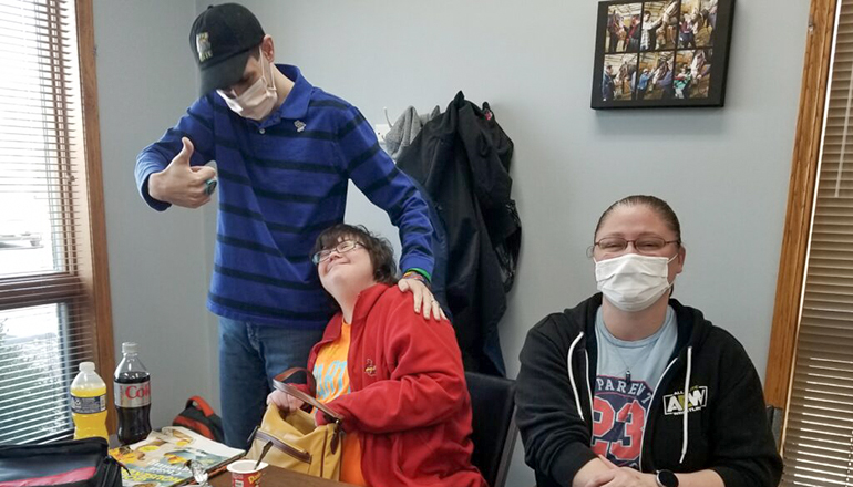 David, left, and Megan, enjoy a moment with community skills teacher Kristin Nobus, right, at the agency’s day program in Troy (Rudi Keller - Missouri Independent)