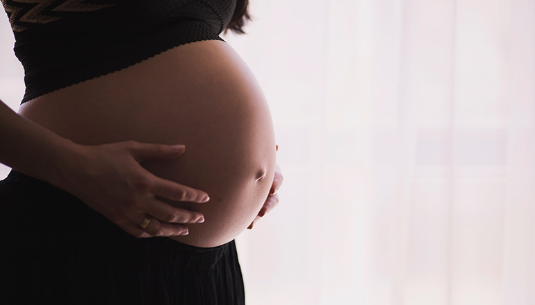 Photo of a pregnant woman (Photo by freestocks on Unsplash)