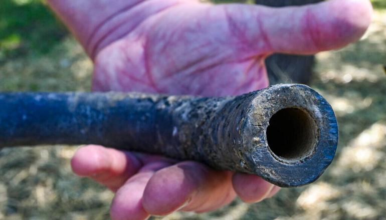 A piece of lead pipe removed from Jerry Land’s yard in Olathe, Kansas (Photo by Carlos Moreno - KCUR)