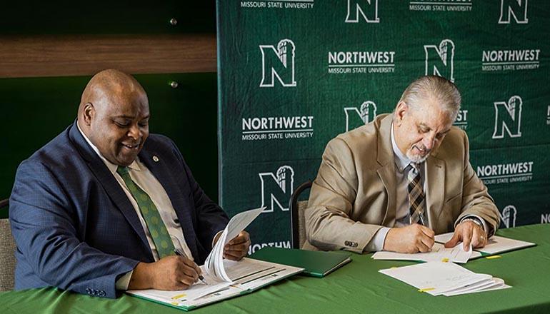 Northwest Interim President Dr. Clarence Green, and North Central President Dr. Lenny Klaver sign agreements