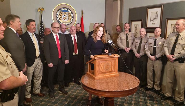 State Sen. Jill Carter speaks to the media surrounded by local sheriffs (Photo by Jason Hancock - Missouri Independent)