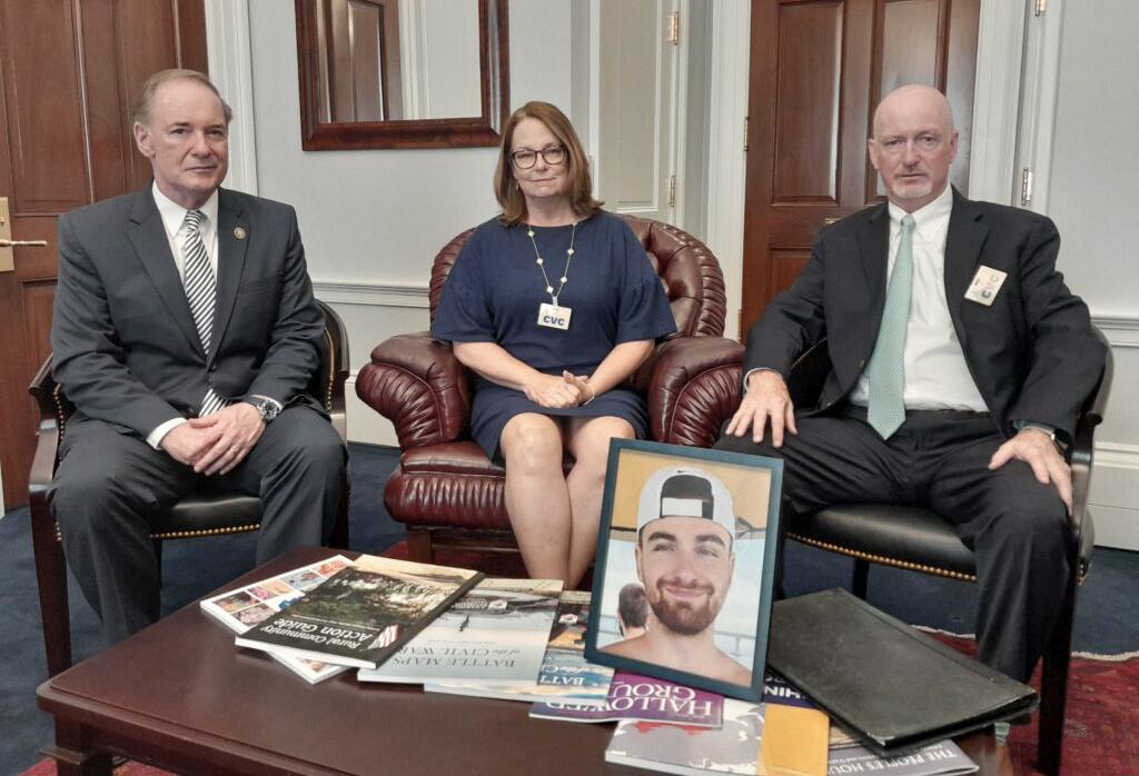 Deb and Ray Cullen, of Shippingport, Pa., center and right, show a photo of their son, Zachary, in the office of their congressman, GOP Rep. John Joyce (Photo by Ashley Murray - States Newsroom)