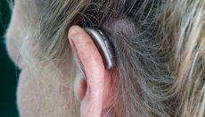 Woman or girl wearing hearing aid (Photo by Mark Paton on Unsplash)