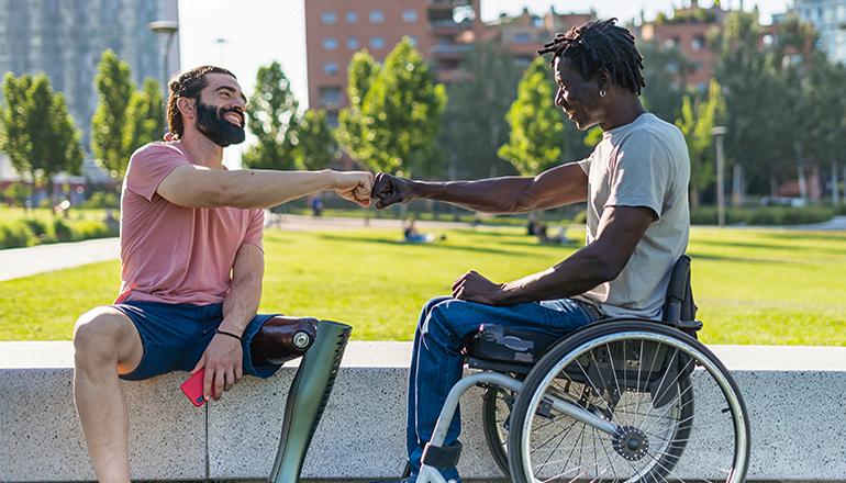 Two disabled friends give fist bump as a sign of friendship (Photo courtesy Missouri News Service)