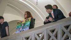 counterprotestor holds a sign over the balcony that says, Trans kids have heartbeats too (Photo by Annelise Hanshaw - Missouri Independent)