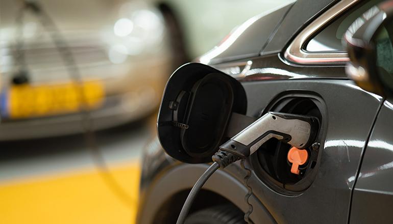 Electric Car Charging News Graphic (Photo by Michael Fousert on Unsplash)
