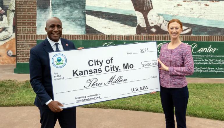 EPA Administrator Meg McCollister presents a $3 million ceremonial check to Kansas City Mayor Quinton Lucas