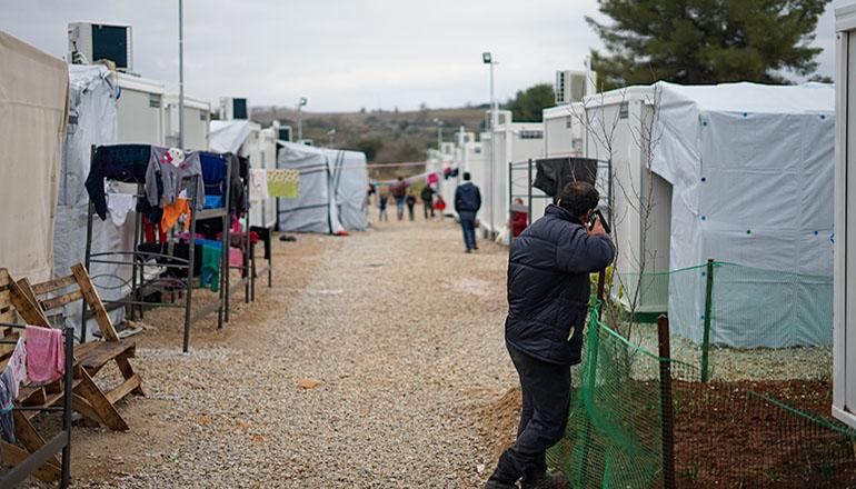 Immigrants in a tent city (Photo by Julie Ricard on Unsplash)