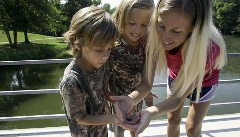 Mother son and daughter holding insect (Photo courtesy Mo Dept. of Conservation)